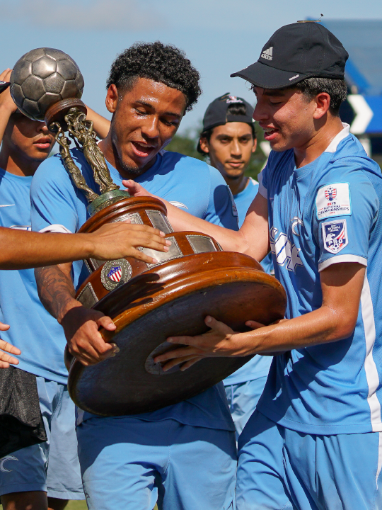 Youth soccer holding a trophy