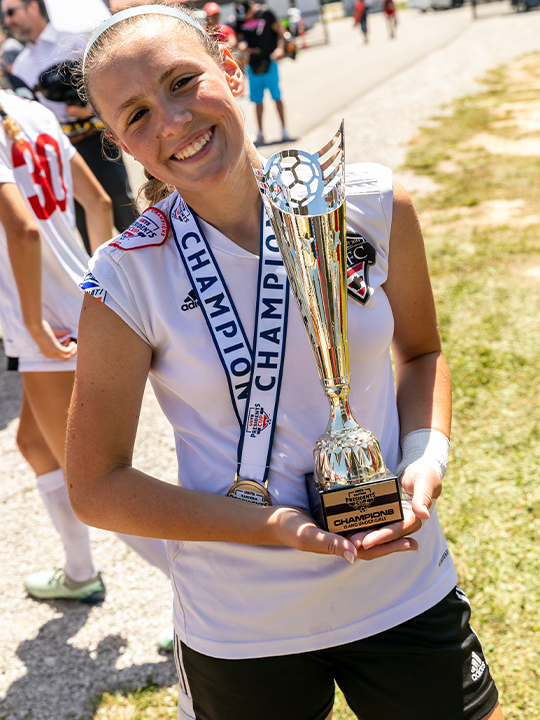 Youth soccer holding a trophy